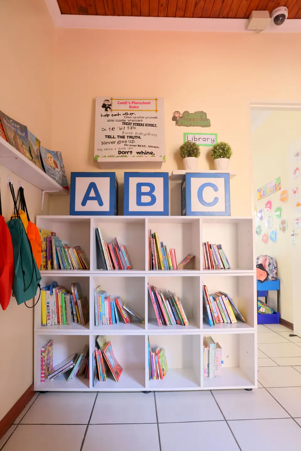A reading corner with ABC blocks and a white bookshelf