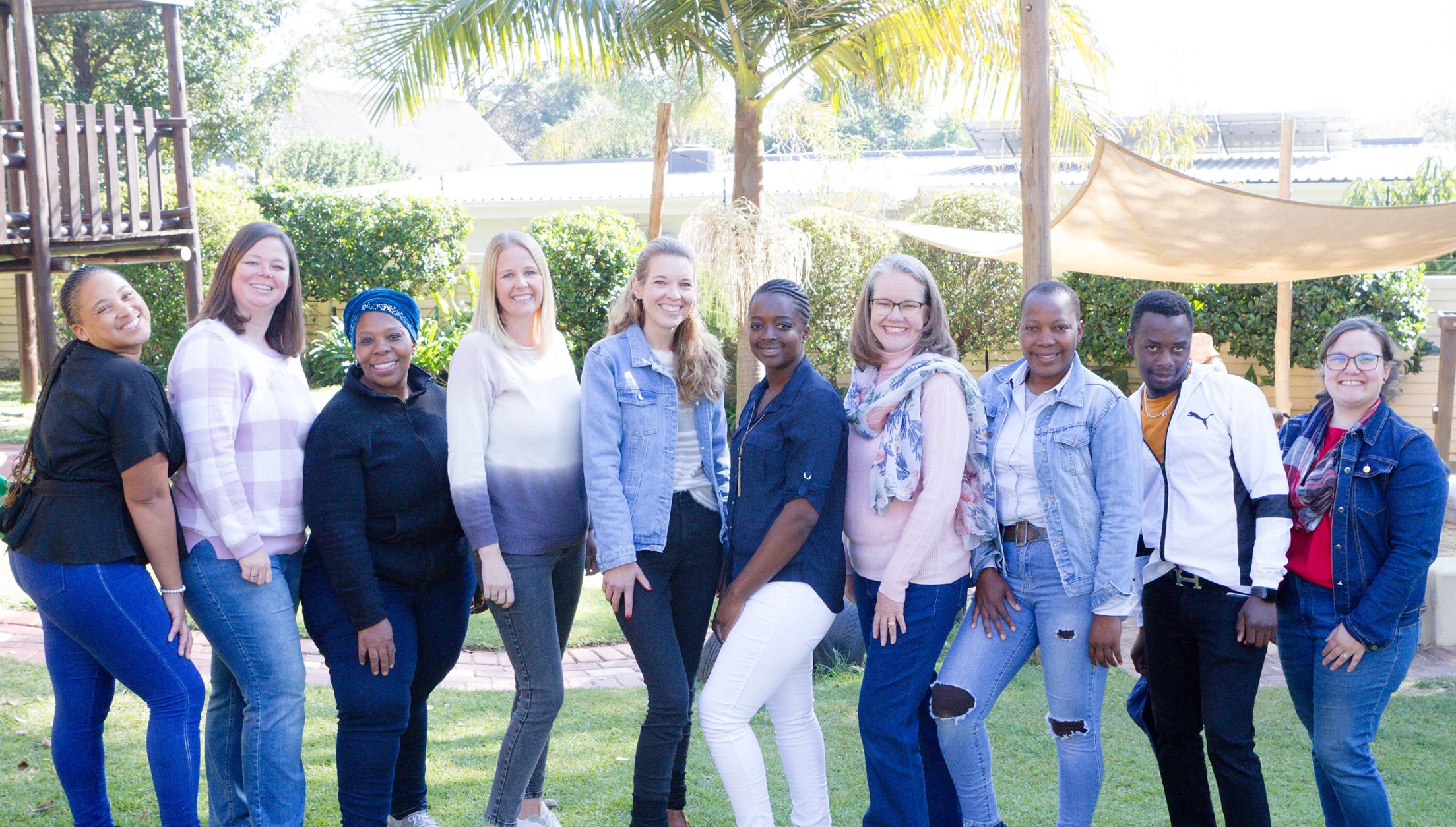 The Candi’s Play + Pre-school staff standing together in the school garden